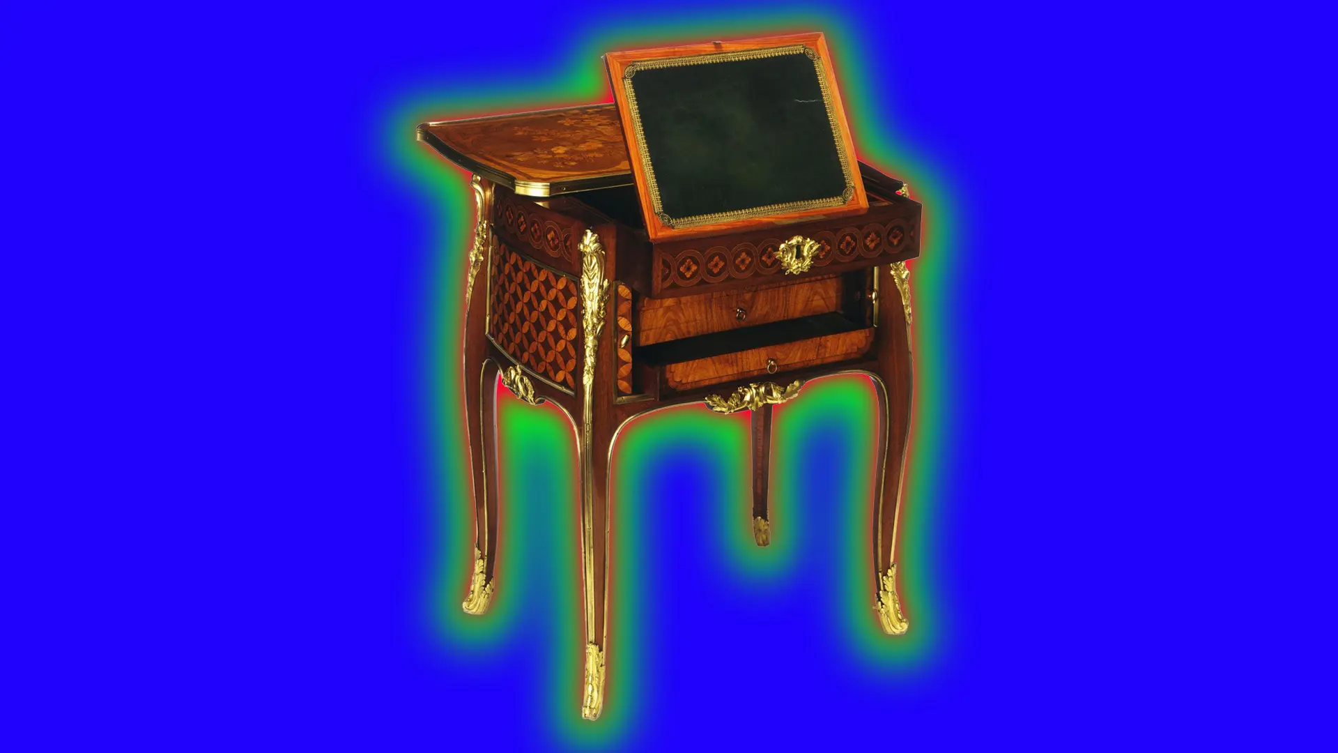An 18th century writing table of mahogany and gold inlay with a slide out writing surface with a black surface and gold adorned feet set against a royal blue background with a green halo.