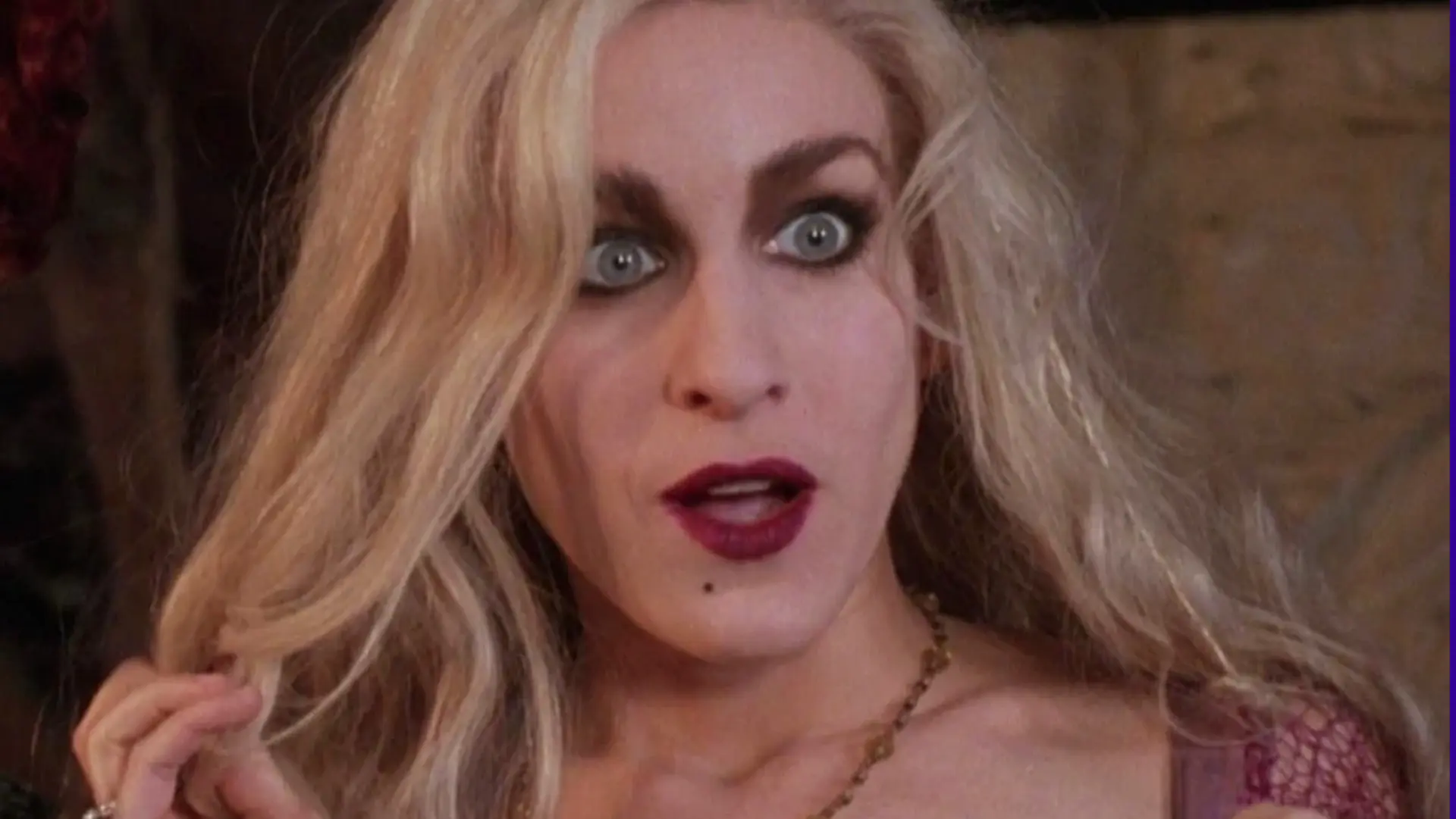 A photo of Sarah Jessica Parker in the movie Hocus Pocus showing her character looking shocked at something in the distance.