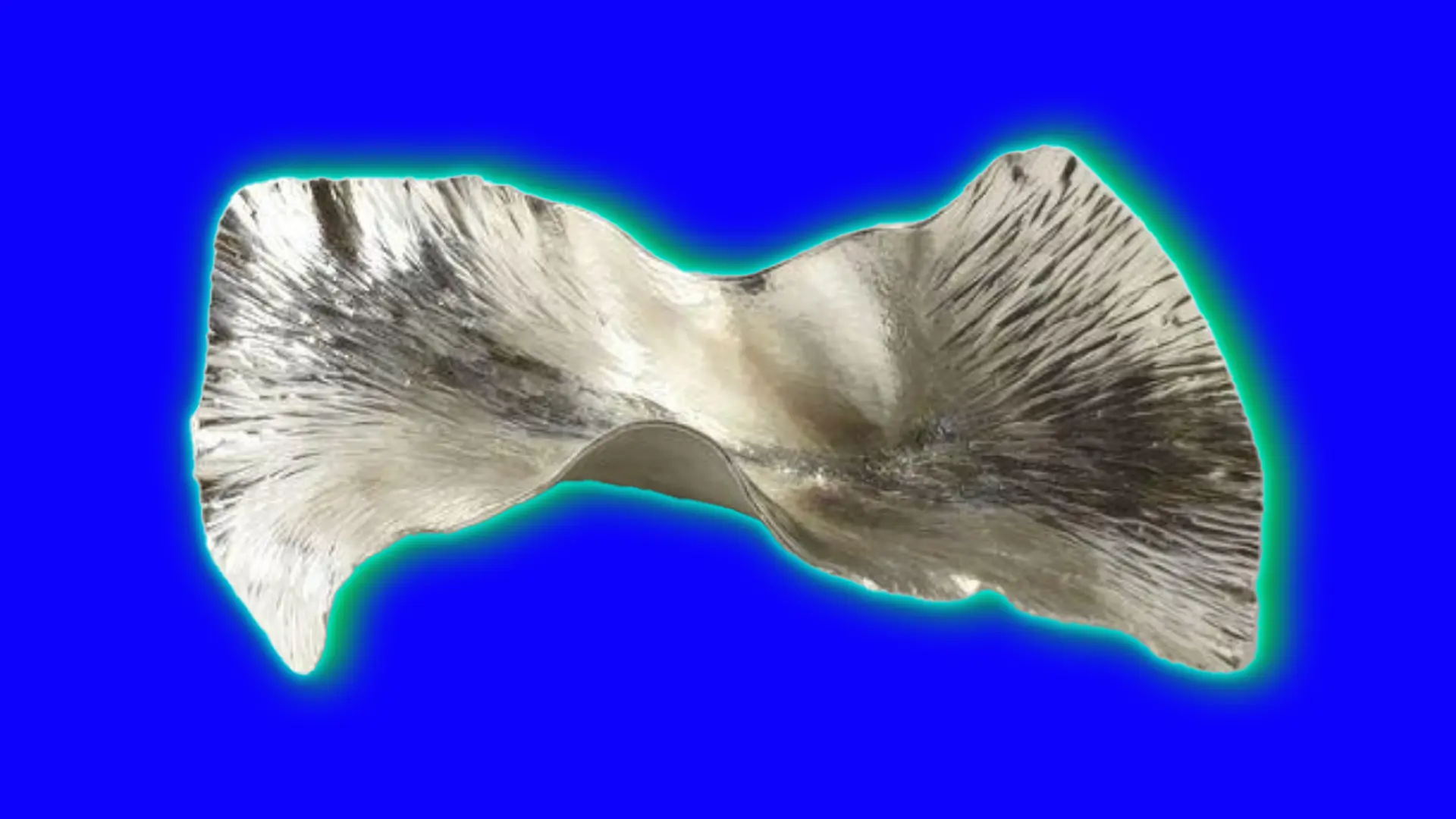 A silver piece of metal contorted into a bent shape with engraved lines across it's surface, set against a royal blue background with a green halo.