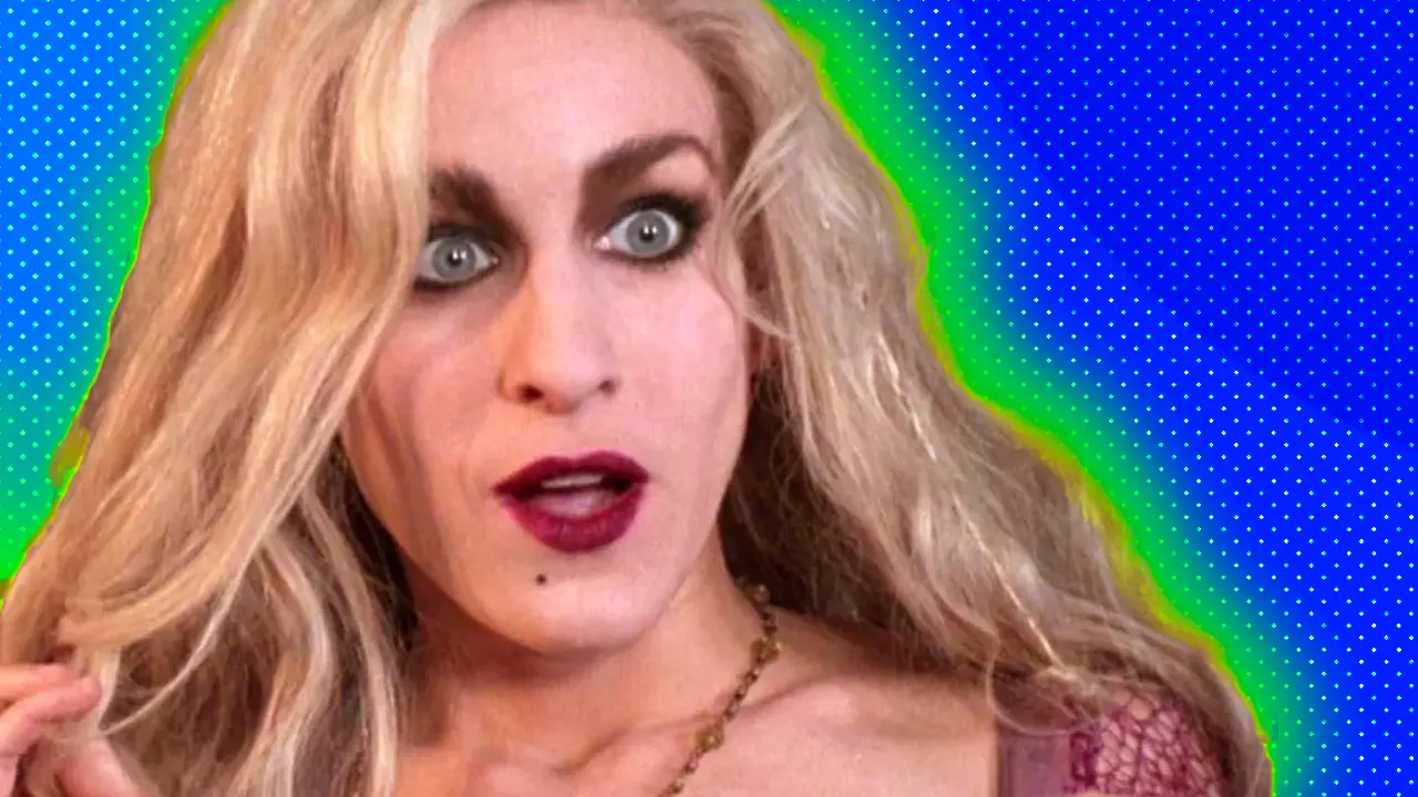 A photo of Sarah Jessica Parker in the movie Hocus Pocus showing her character looking shocked at something in the distance set against a blue dotted background with a green halo.