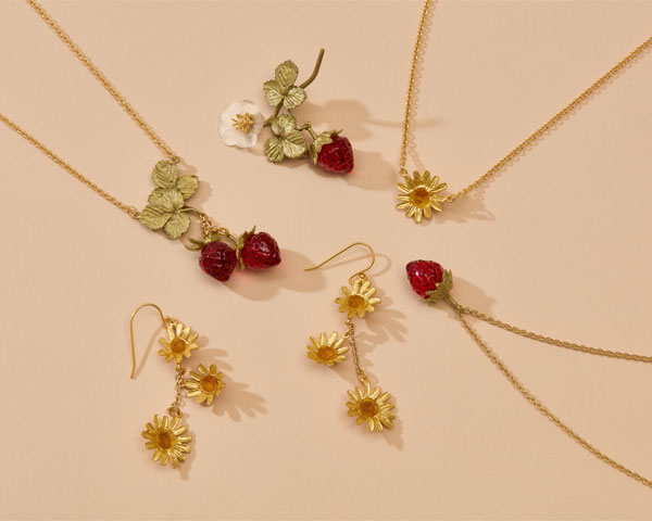 Earrings, necklaces and brooches with summer floral and fruit motifs.