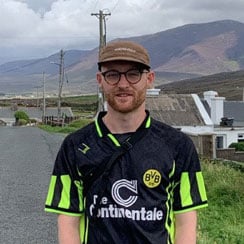 Illustrator Gavin Connell poses outdoors for a headshot.