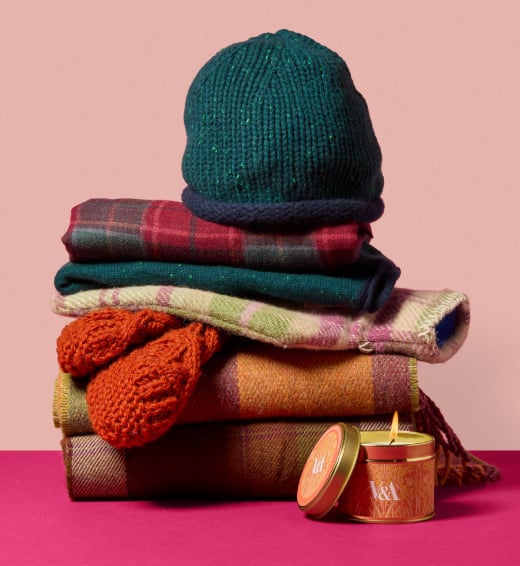 A stack of wonderful woolly scarves, with chunky slipper socks and a cashmere hat