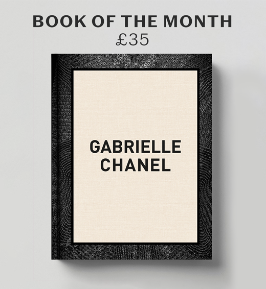 Book cover of the Gabrielle Chanel exhibition book.The title, in black capital letters, is written on a cream background and framed by a black band.