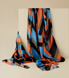 A lightweight scarf featuring an Art Deco zig zag pattern in bright orange, blue and black.