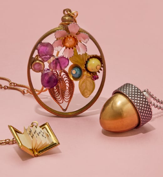 Three whimsically styled pendant necklaces; a mosaic of vintage gemstones, and two lockets with secret messages inside